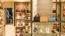 Chic boutique with a variety of handbags and shoes elegantly displayed on shelves.