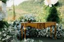 Ornate table with floral arrangements outdoors