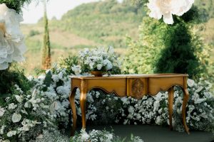 Ornate table with floral arrangements outdoors
