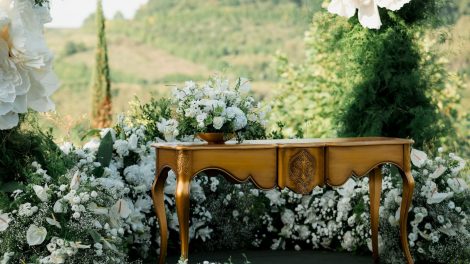 Ornate table with floral arrangements outdoors