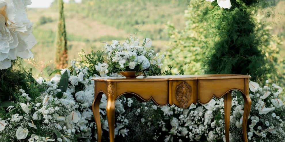 Ornate table with floral arrangements outdoors